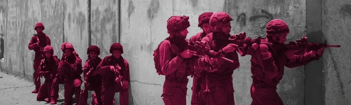 A photo of 9 Israeli soldiers holding guns during a training exercise.